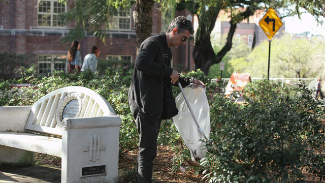 Ain Gordon picks up trash during the Landis Green clean-up