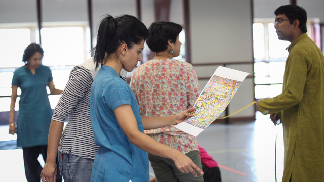 Ragamala creates a game board on the floor of the studio to use in rehearsal