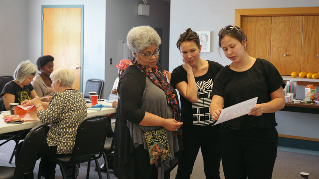 Emily Johnson and Maggie Thompson with community members at the Sewing Bee