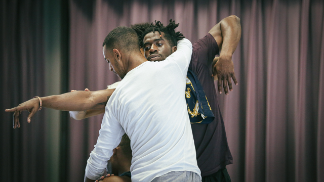 Jonathon Gonzalez, Shamar Watt and performers in rehearsal