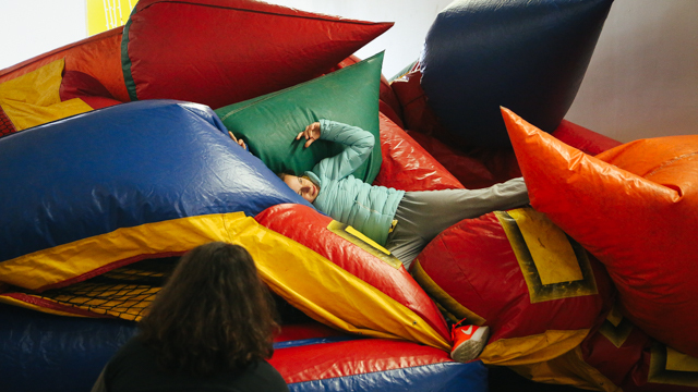 Ivonne Batanero on top of bounce house at 621 Gallery