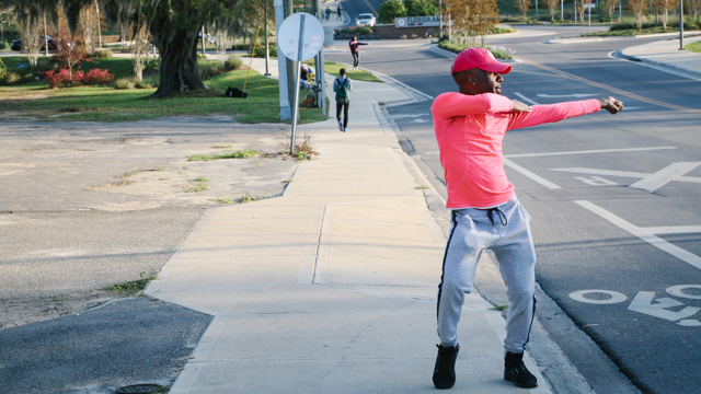 Jermone Beacham dancing in front of FAMU campus