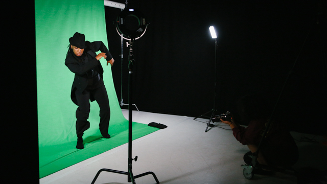 Beatrice Capote dances in front of a green screen