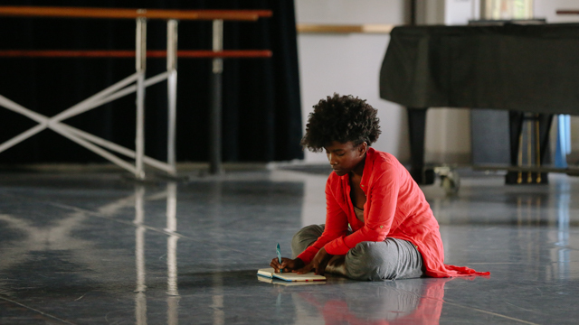 Melanie Greene works on her writing practice in the studio