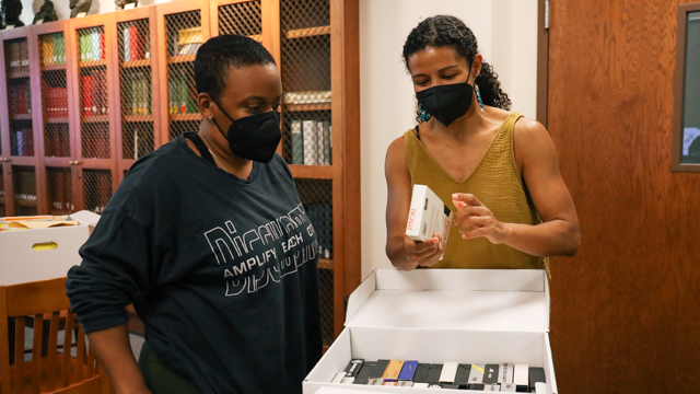 Audrey Hailes and Maria Bauman check out resources to aid them in the choreographic process.