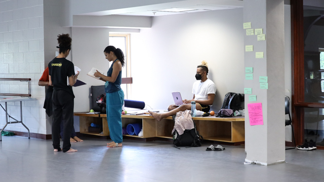 Mozie, Stiggers, and Bauman discuss materials from the archive while MANCC Embedded Writer<br>jumatatu poe observes and writes.