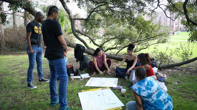 Dr. Chioke I'Anson, Embedded Writer jumatatu poe, Bauman, Stiggers, Mozie, and Hailes in discussion<br>on Landis Green