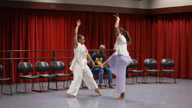 Hailes and Mozie dance while Dr. I'Anson takes notes