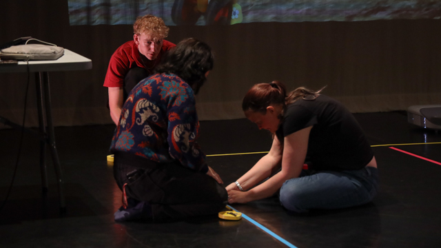 Mariah Preedin (MANCC staff), and MANCC Intern, Emmett Higgins work with Stage Manager<br>Amanda Eno (right) to prepare for <em>NORRI</em> showing