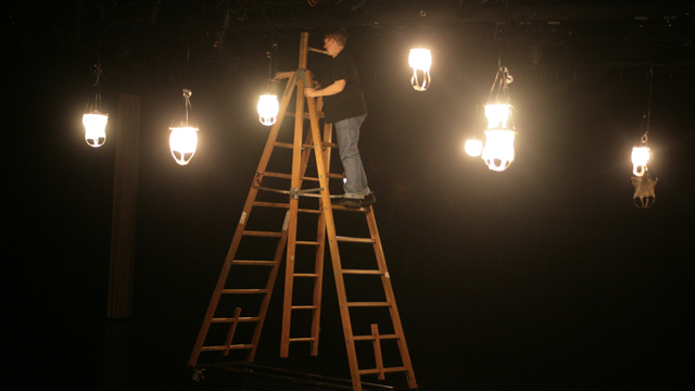 Lighting Designer Heidi Eckwall hangs Johnson's fish skin lanterns in the Black Box Studio.